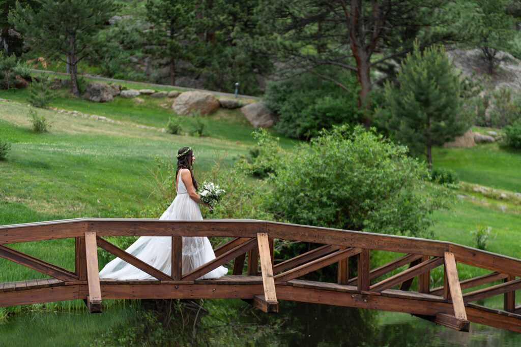 bride walking across wooden bridge