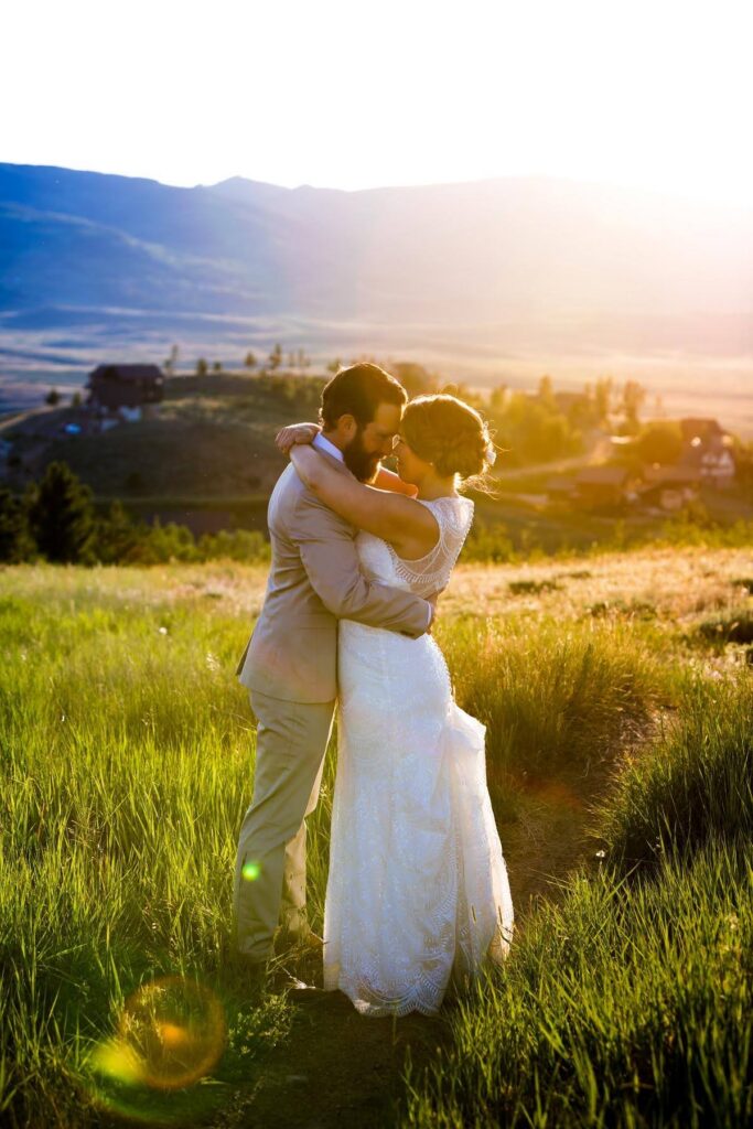Bride and groom embrace at golden hour