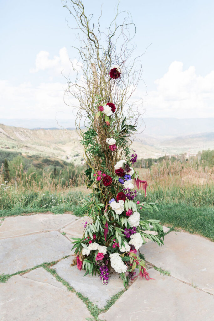 Floral ceremony arch with Colorado mountains
