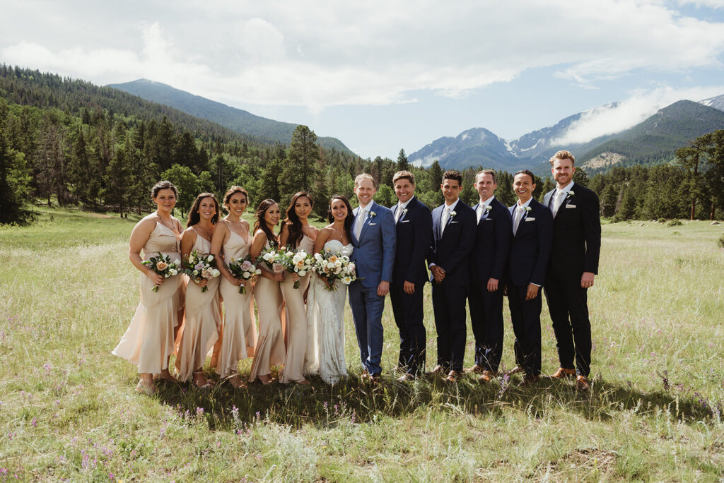Wedding party posing with Rocky Mountains in the background