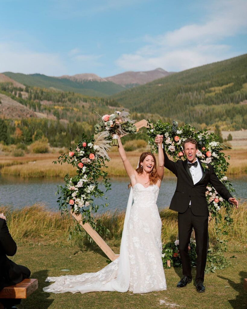 Newlyweds celebrate at lakeside wedding ceremony in Colorado