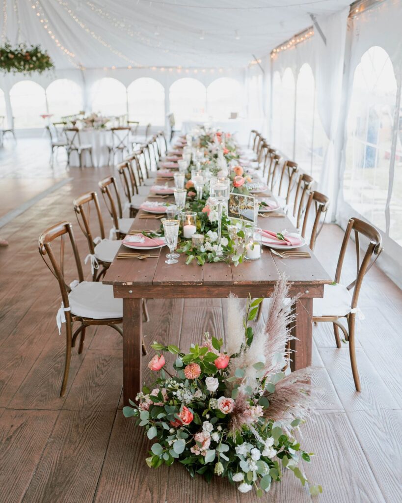 Head table design at tented outdoor Colorado wedding reception