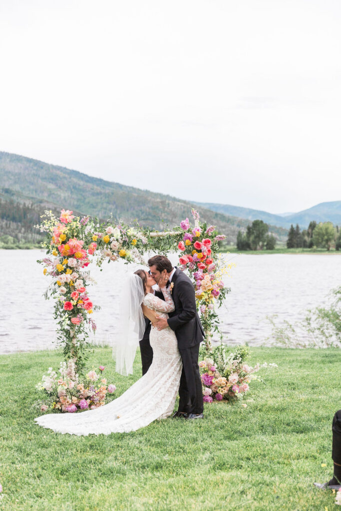 Newlyweds kiss at outdoor wedding in Colorado
