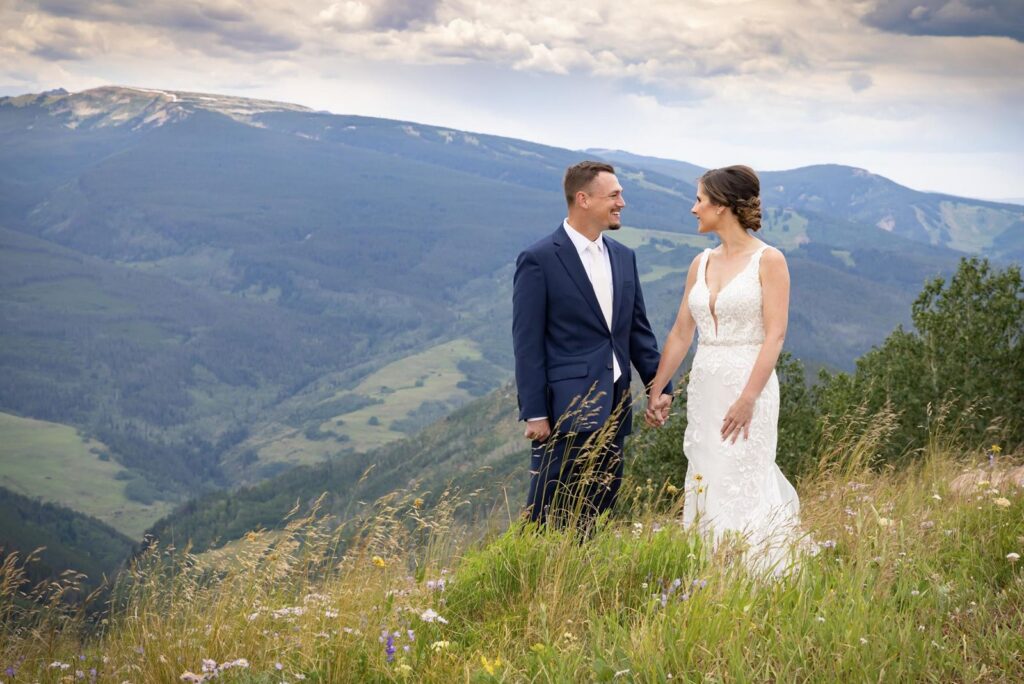 Bride and groom pose with Colorado mountains in the background